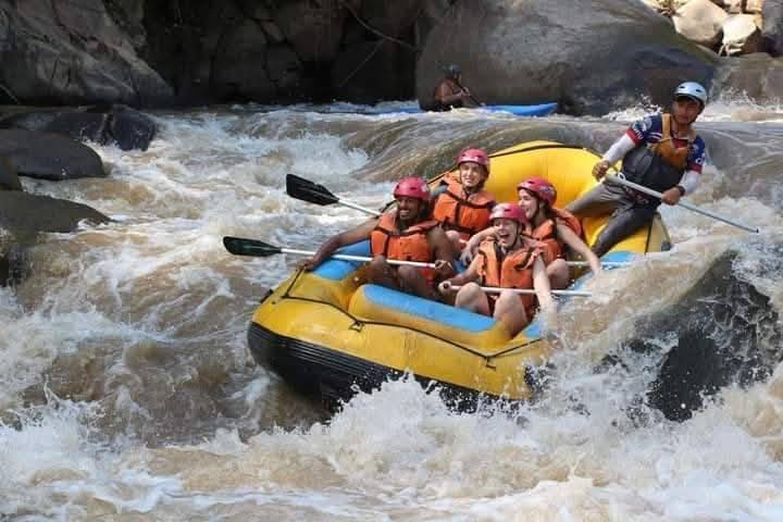 A raft crashing through white water rapids on the Mae Taeng River, Chiang Mai